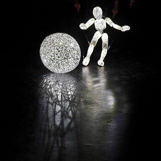 DUNDU puppet approaches sphere of light